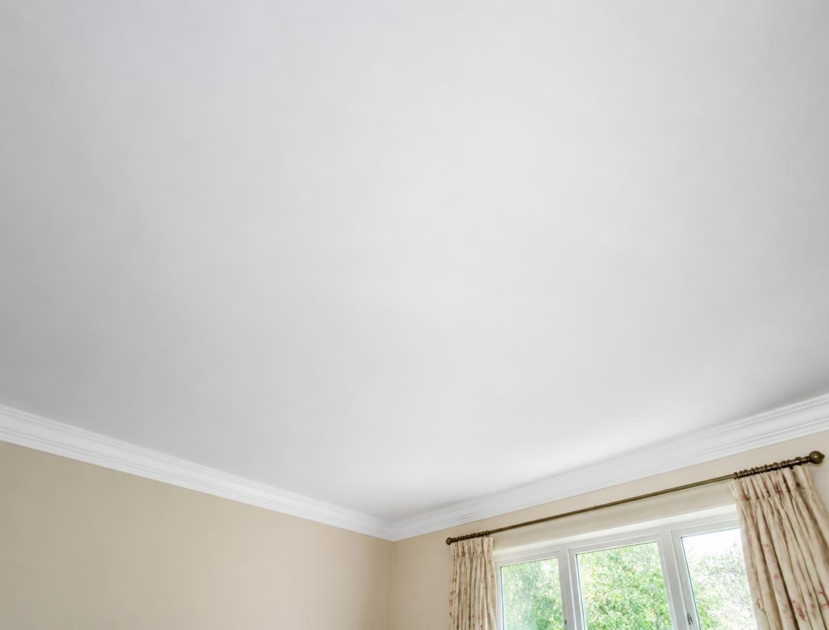 Repaired and repainted ceiling after water damage drywall repair in a San Diego home